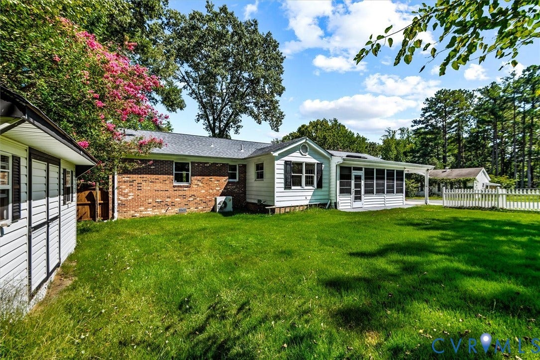 13012 Harrowgate Road, Chesterfield, VA 23831 Expansive green lawn, white siding exterior, brick facade, screened porch, and a white picket fence