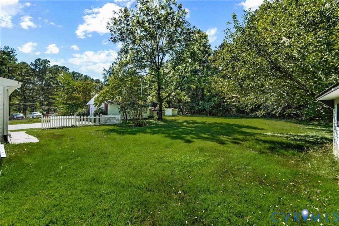 13012 Harrowgate Road, Chesterfield, VA 23831 Expansive green lawn with mature trees and a white picket fence
