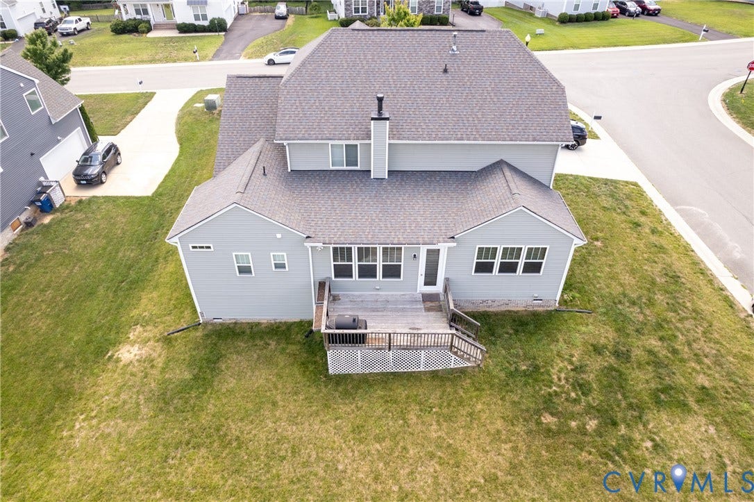 Rear exterior with a multi-level deck, light gray siding, and a dark gray shingle roof