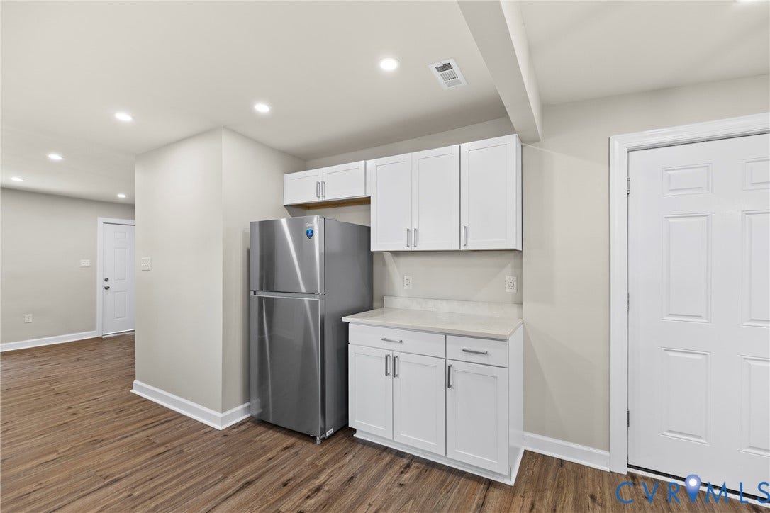 606 Effingham Drive, Woodhaven, Richmond, VA 23224 Wood-finish flooring with white baseboards, recessed lighting, and stainless steel refrigerator
