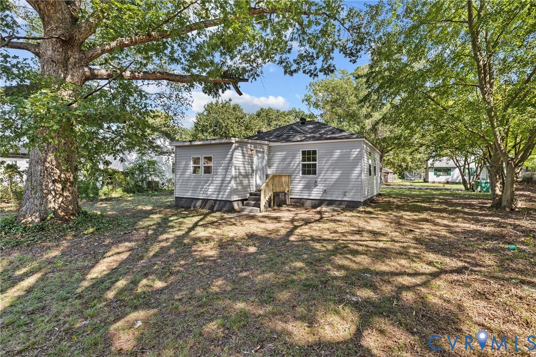 606 Effingham Drive, Woodhaven, Richmond, VA 23224 Rear exterior featuring light gray siding, a dark roof, and a wood-finish staircase