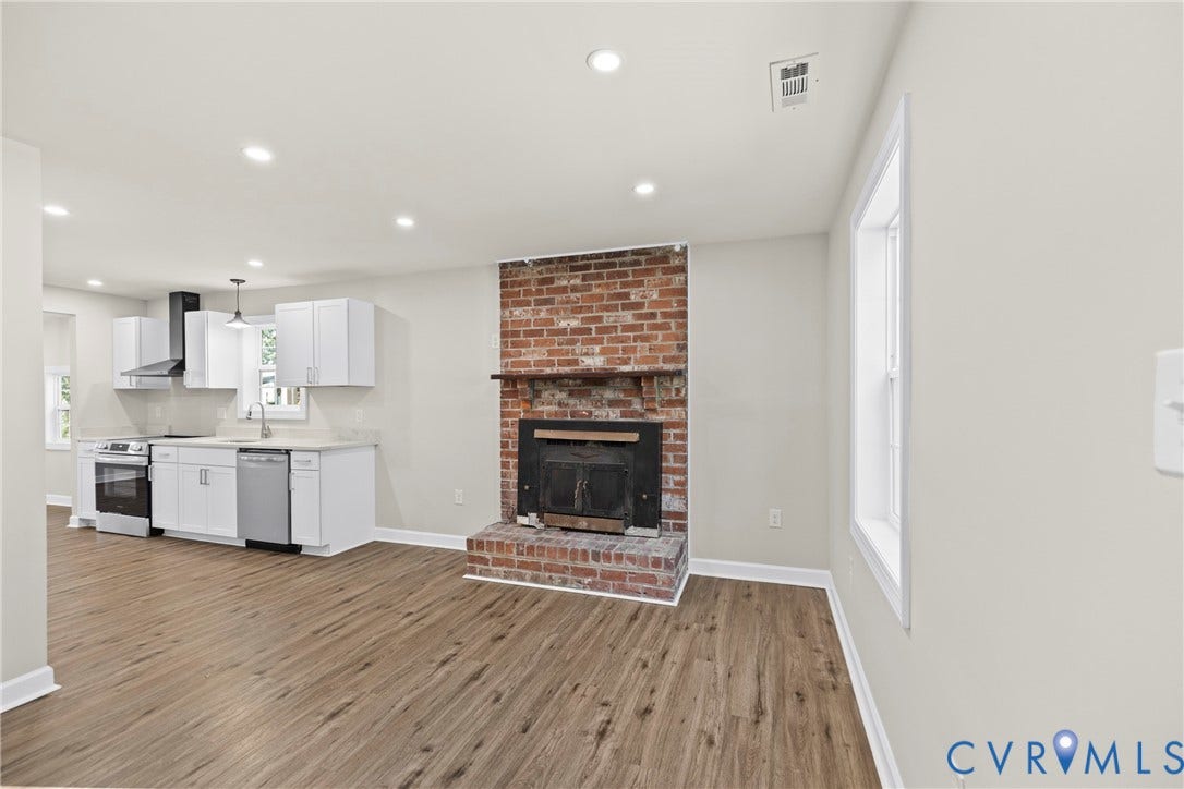 606 Effingham Drive, Woodhaven, Richmond, VA 23224 Wood-finish flooring throughout, brick fireplace with wood mantel, recessed lighting, white shaker-style cabinetry, and stainless steel appliances