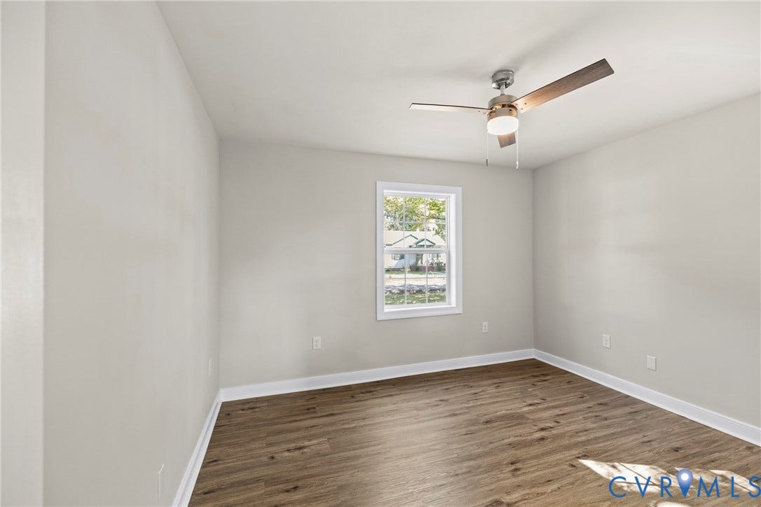 606 Effingham Drive, Woodhaven, Richmond, VA 23224 Wood-finish flooring, neutral wall tones, window with white trim, and a ceiling fan with integrated lighting