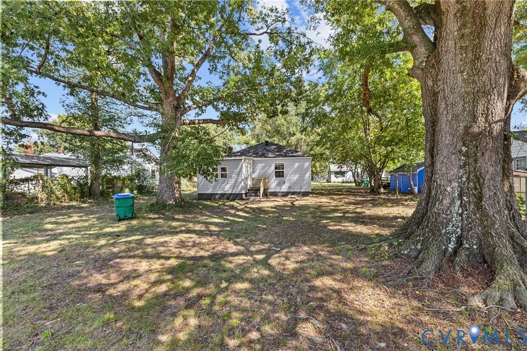 606 Effingham Drive, Woodhaven, Richmond, VA 23224 Expansive backyard with a manicured lawn, mature trees, and a detached structure