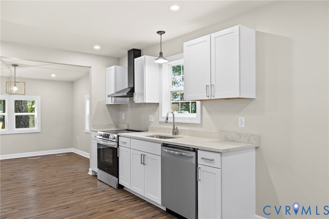 606 Effingham Drive, Woodhaven, Richmond, VA 23224 Kitchen featuring white cabinetry, light-toned countertops, stainless steel appliances, and wood-finish flooring