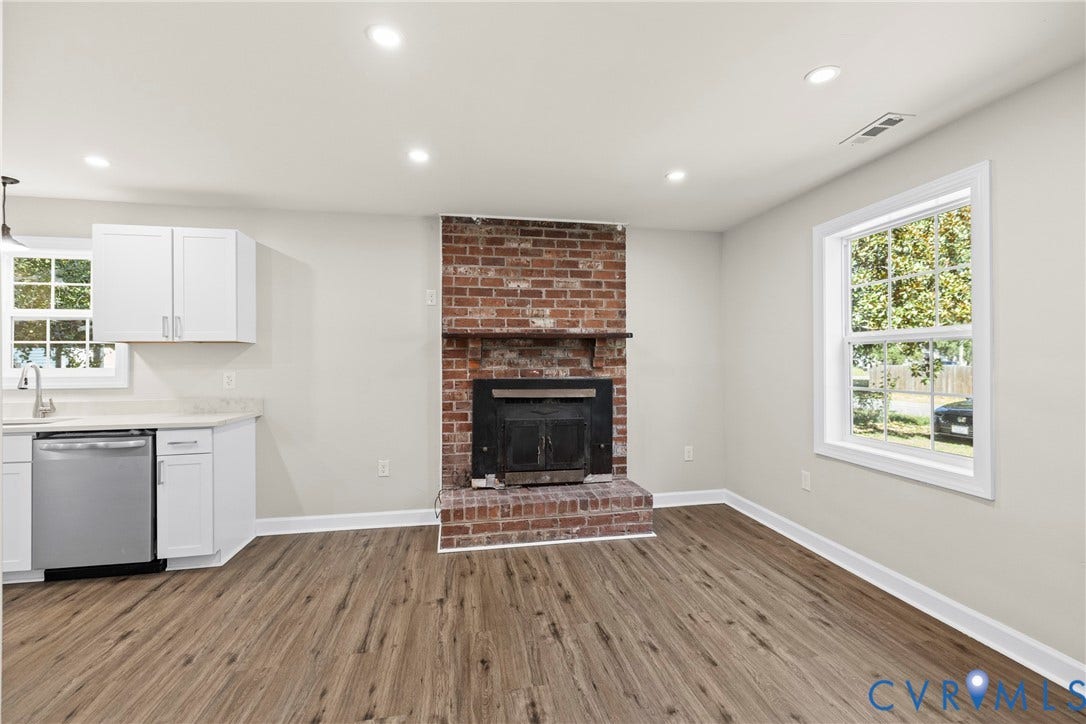 606 Effingham Drive, Woodhaven, Richmond, VA 23224 Brick fireplace with mantle, wood-finish flooring, white cabinetry, stainless steel dishwasher, and recessed lighting