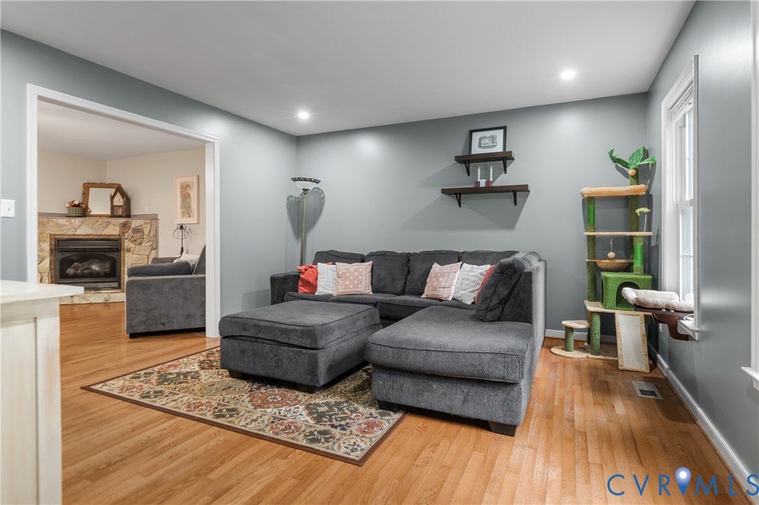 Hardwood flooring throughout, recessed ceiling lighting, built-in shelving, and a prominent window