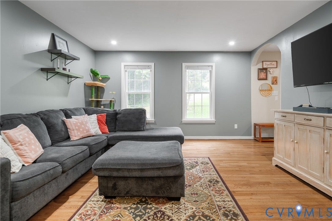 Hardwood flooring, recessed lighting, two windows, arched doorway