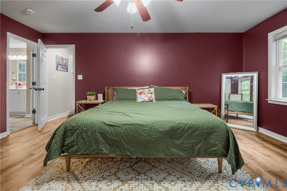 Wood-finish flooring, ceiling fan, and white trim