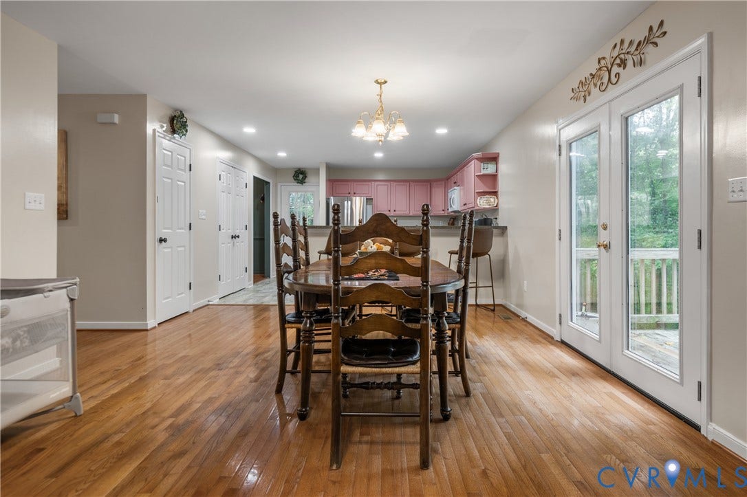 Hardwood flooring, recessed lighting, and a chandelier