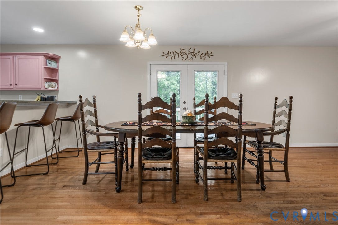 Wood-finish flooring throughout, with a built-in breakfast bar featuring a light-toned countertop