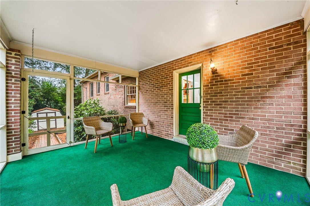 7548 Piney Branch Road, Stratford Hills, Richmond, VA 23225 Screened porch featuring brick wall construction, green door with glass paneling, and an outdoor light fixture