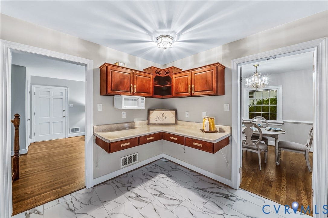7548 Piney Branch Road, Stratford Hills, Richmond, VA 23225 Built-in cabinetry with wood-finish doors, solid surface countertop, and marble-look tile flooring