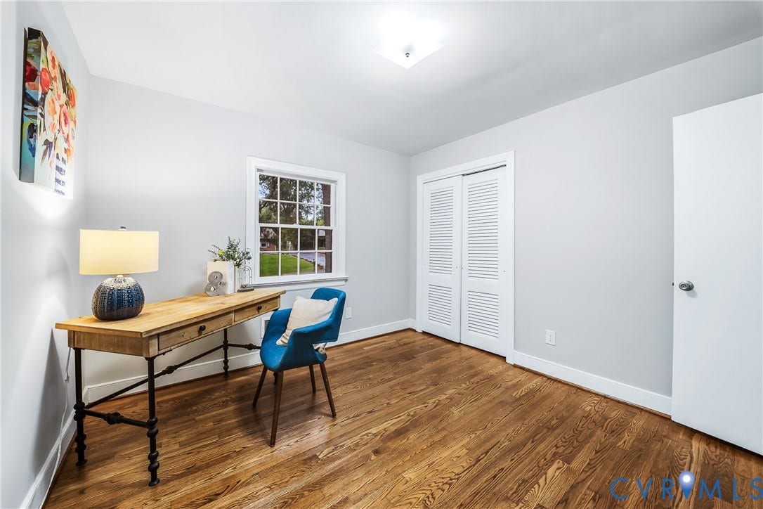7548 Piney Branch Road, Stratford Hills, Richmond, VA 23225 Hardwood flooring, painted walls, a window with exterior visibility, a closet with louvered bifold doors, and a flush mount ceiling light