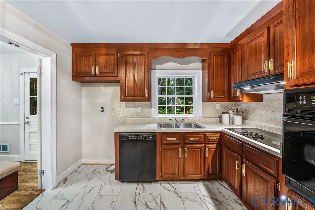 7548 Piney Branch Road, Stratford Hills, Richmond, VA 23225 Kitchen featuring wood cabinetry, stainless steel double basin sink, electric cooktop, built-in oven, and white marble-look tile flooring