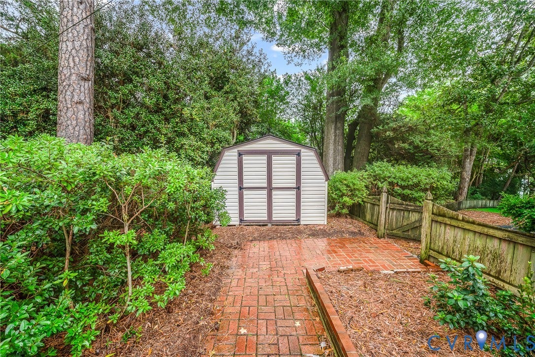7548 Piney Branch Road, Stratford Hills, Richmond, VA 23225 Outbuilding with double doors, brick paver pathway, and wood privacy fencing