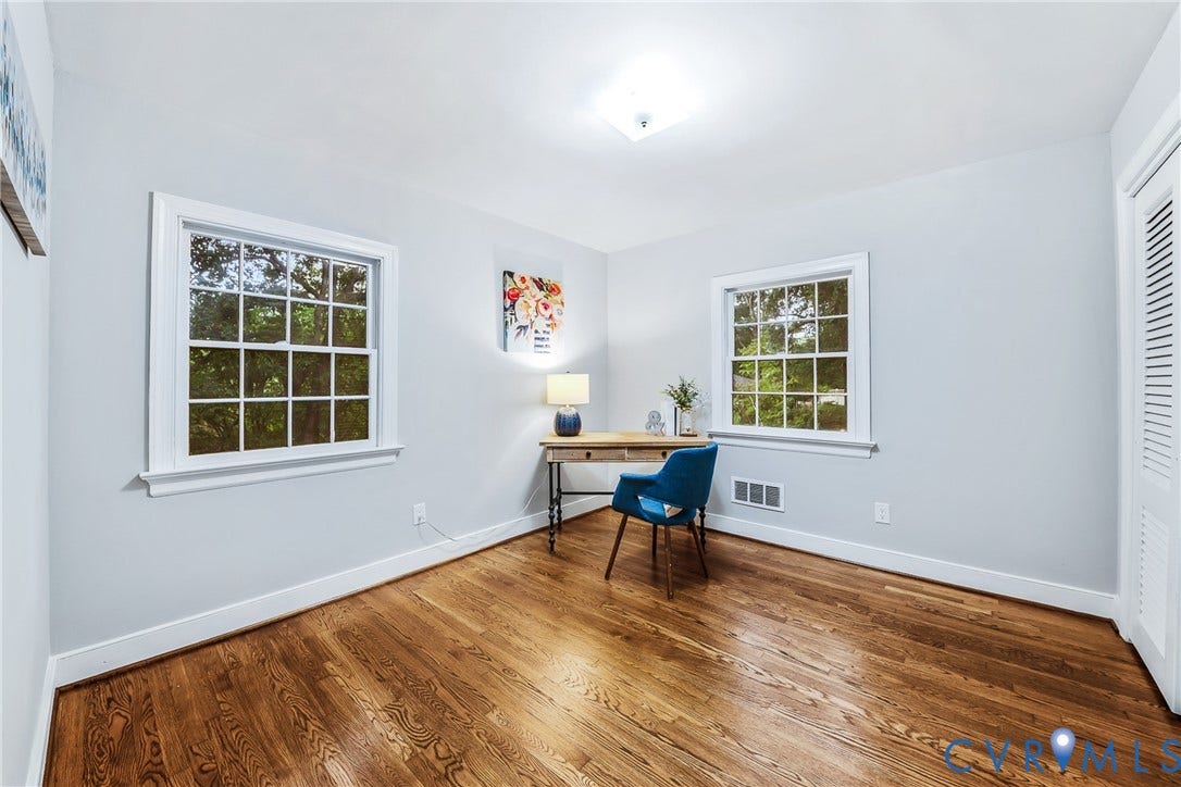 7548 Piney Branch Road, Stratford Hills, Richmond, VA 23225 Hardwood flooring, painted walls, two multi-pane windows with white trim, and a built-in closet with louvered bifold doors