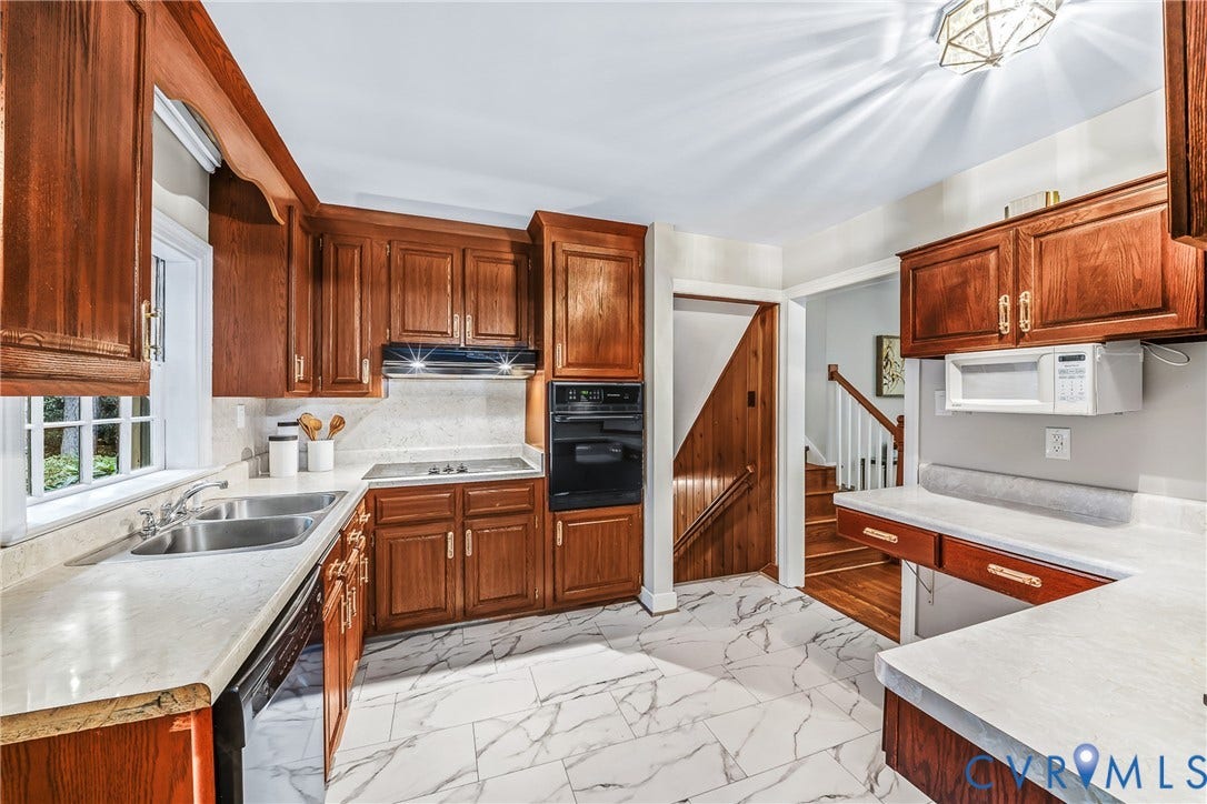 7548 Piney Branch Road, Stratford Hills, Richmond, VA 23225 Kitchen featuring wood cabinetry, solid surface countertops, a stainless steel double basin sink, and integrated wall oven