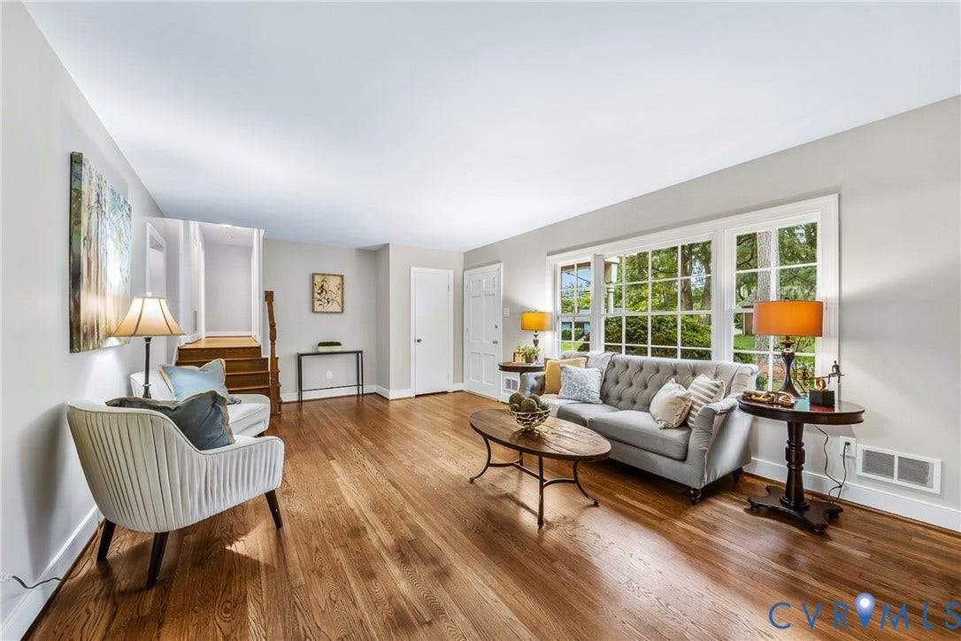 7548 Piney Branch Road, Stratford Hills, Richmond, VA 23225 Hardwood flooring, white trim, multiple windows, and a staircase with wood railing