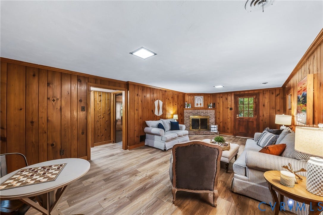 7548 Piney Branch Road, Stratford Hills, Richmond, VA 23225 Wood paneling, wood-finish flooring, brick fireplace with metal insert, recessed lighting, and a wood door with glass panes