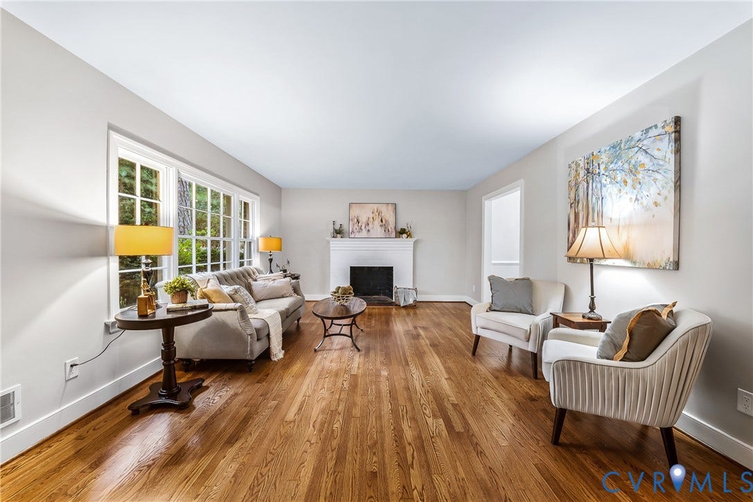 7548 Piney Branch Road, Stratford Hills, Richmond, VA 23225 Hardwood flooring, white wall paint, multiple pane windows, white trim, and a built-in fireplace