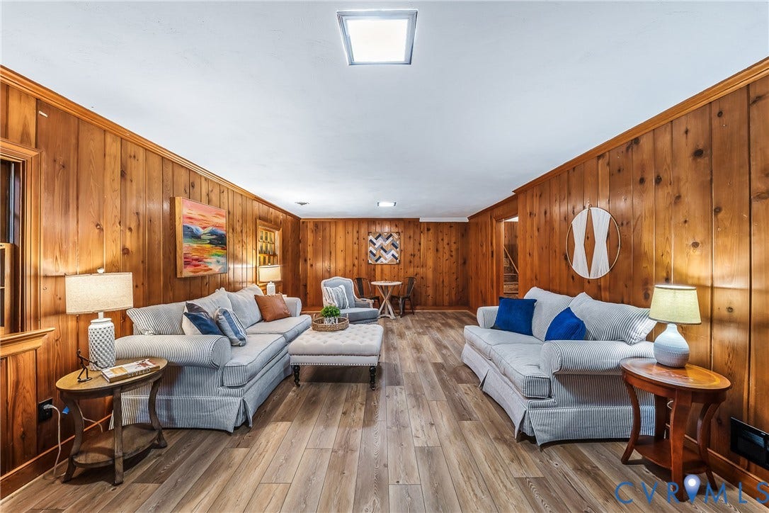 7548 Piney Branch Road, Stratford Hills, Richmond, VA 23225 Wood-paneled walls defining a spacious room with wood-finish flooring