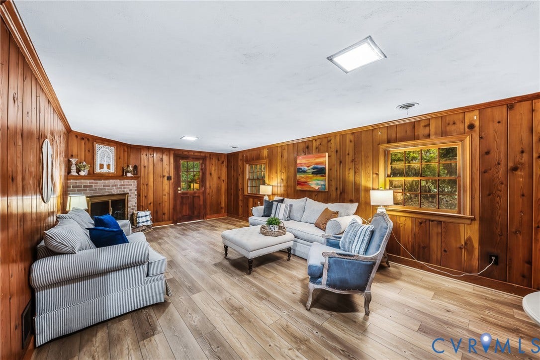 7548 Piney Branch Road, Stratford Hills, Richmond, VA 23225 Wood-finish flooring, wood paneling, exposed brick fireplace, and built-in lighting fixtures