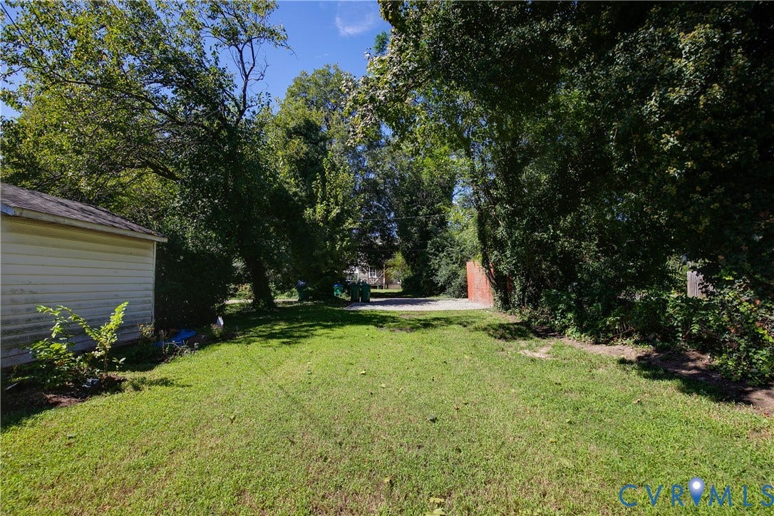 3314 3rd Avenue, Northside, Richmond, VA 23222 Expansive green lawn with mature trees and a detached structure featuring horizontal siding