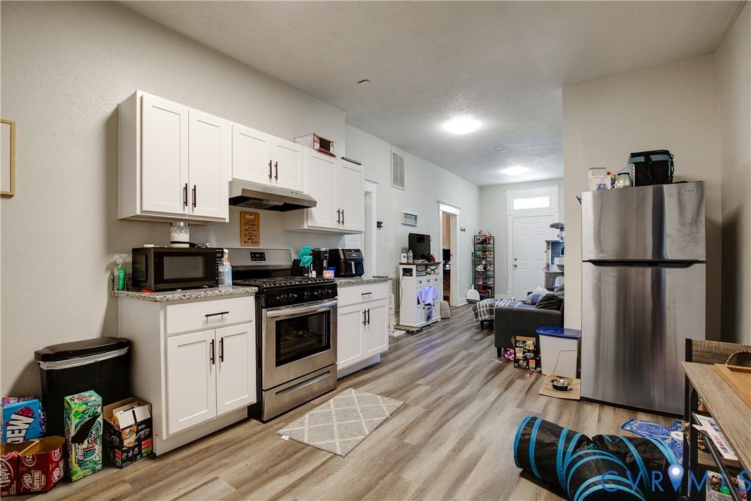 3314 3rd Avenue, Northside, Richmond, VA 23222 Kitchen featuring white shaker cabinetry, stainless steel appliances, granite-style countertops, and wood-finish flooring