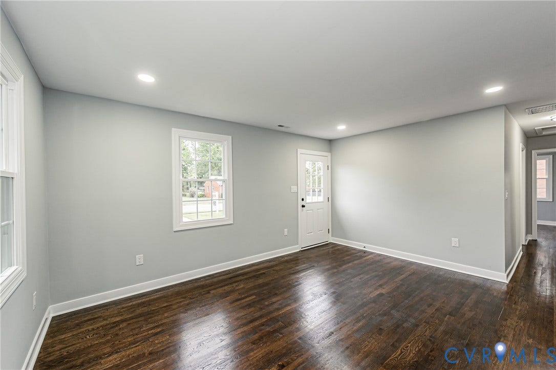 1608 Bryan Street, Richmond, VA 23223 Refinished wood-finish flooring, light gray wall paint, recessed ceiling lighting, white trim, and a white paneled door with lites
