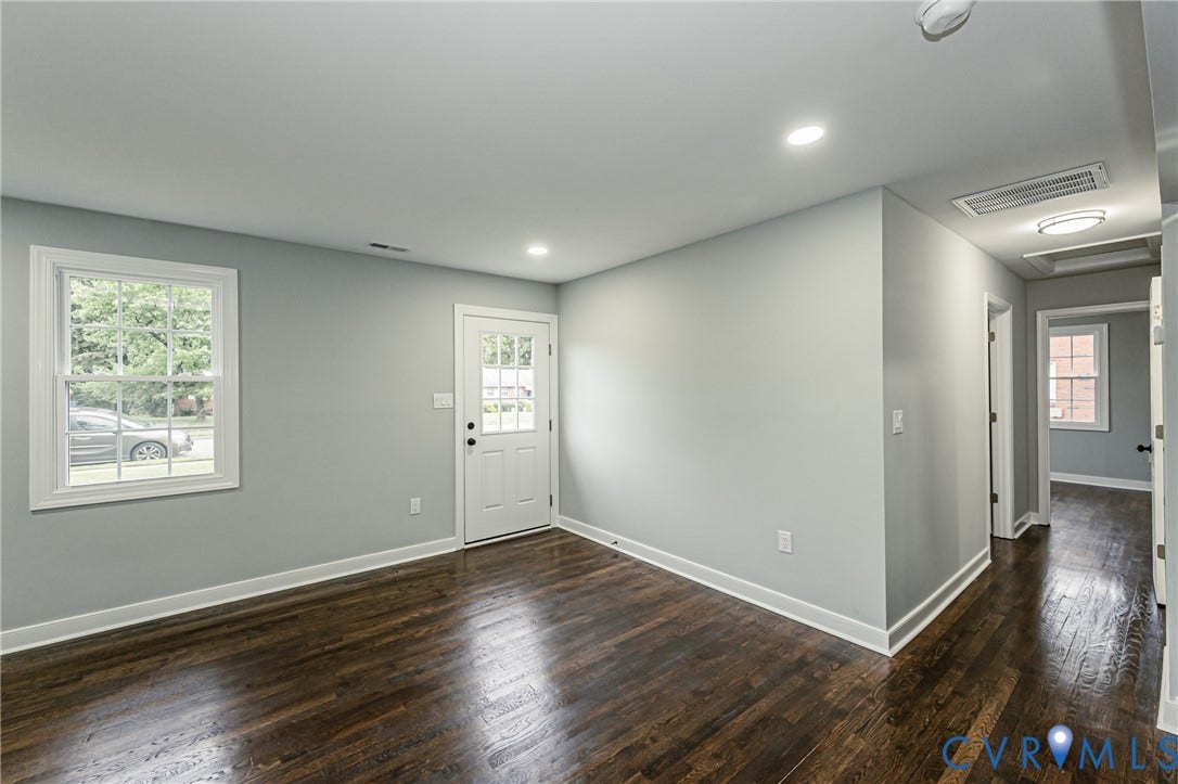 1608 Bryan Street, Richmond, VA 23223 Hardwood flooring, recessed lighting, double-hung window, white paneled door with glass inserts, and a hallway with overhead lighting