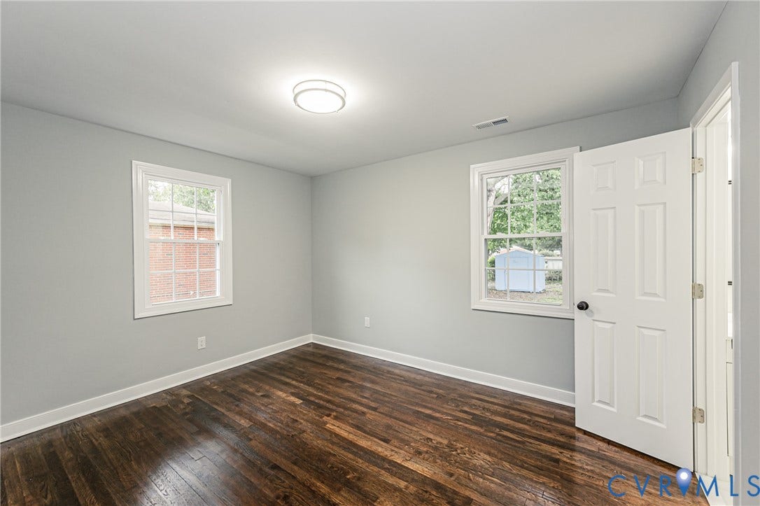 1608 Bryan Street, Richmond, VA 23223 Wood-finish flooring, light gray wall paint, and white trim