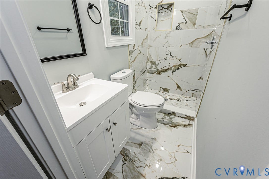 1608 Bryan Street, Richmond, VA 23223 White vanity with a single basin sink and brushed nickel faucet