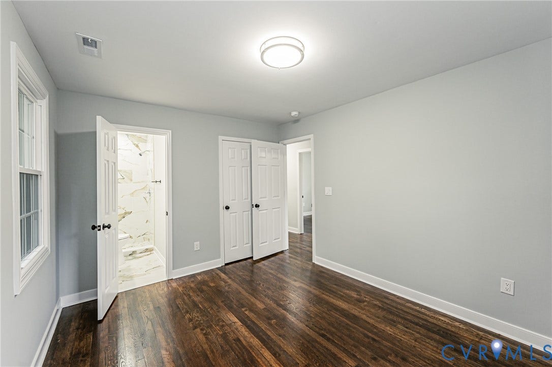 1608 Bryan Street, Richmond, VA 23223 Rich wood-finish flooring, crisp white trim, and a modern flush-mount ceiling light