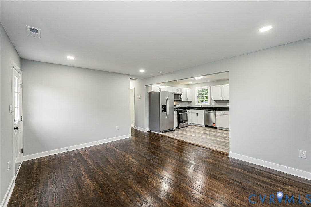 1608 Bryan Street, Richmond, VA 23223 Hardwood flooring, recessed lighting, and a kitchen featuring stainless steel appliances, white cabinetry, and dark countertops