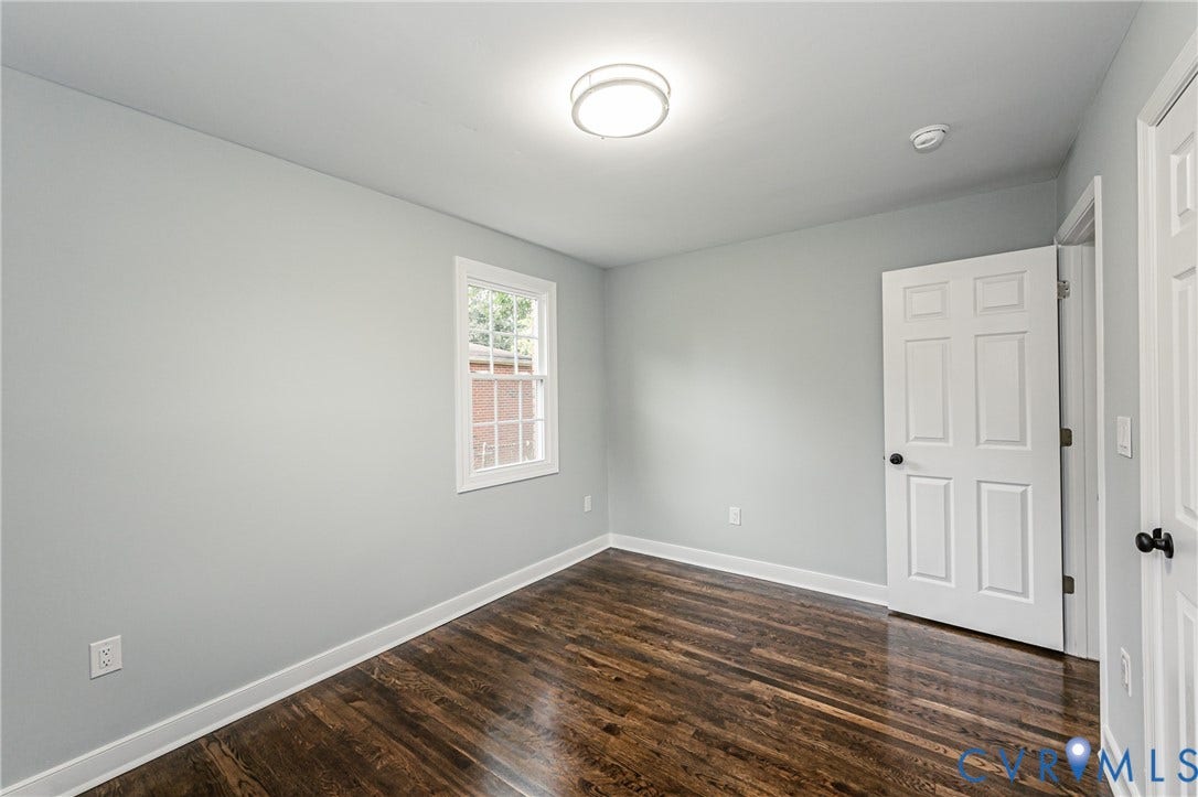 1608 Bryan Street, Richmond, VA 23223 Hardwood flooring, light gray walls, white trim, recessed lighting, and a white four-panel door