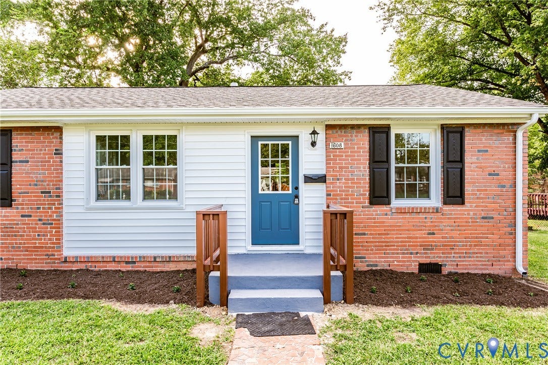 1608 Bryan Street, Richmond, VA 23223 Brick and siding exterior with a vibrant blue front door