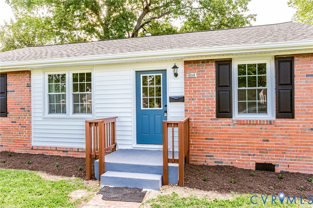 1608 Bryan Street, Richmond, VA 23223 Brick and siding facade with a blue entry door, white trim, and dark shutters