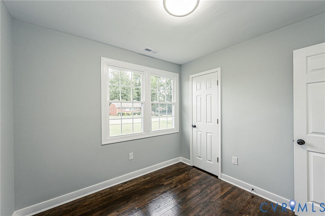 1608 Bryan Street, Richmond, VA 23223 Wood-finish flooring, light gray wall paint, and white trim throughout