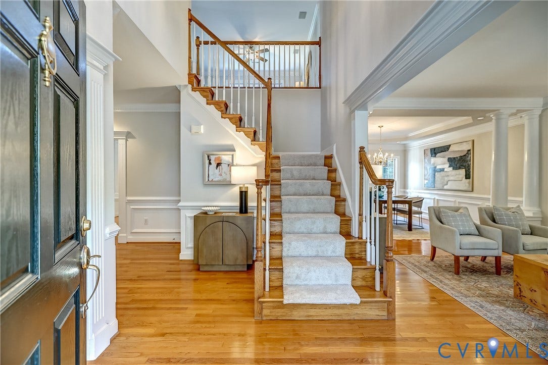5204 Harvest Glen Drive, Twin Hickory, Glen Allen, VA 23059 Two-story entryway with hardwood flooring, a grand staircase with carpet runner, and extensive crown molding and wainscoting