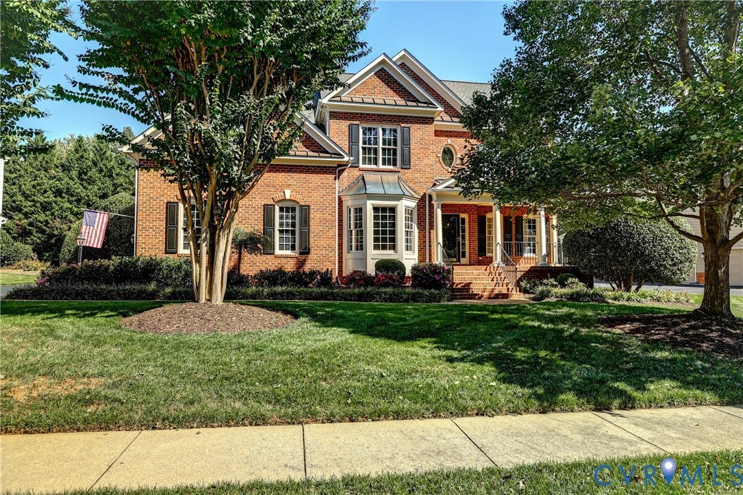 5204 Harvest Glen Drive, Twin Hickory, Glen Allen, VA 23059 Brick exterior featuring a bay window, covered front porch with columns, and mature landscaping