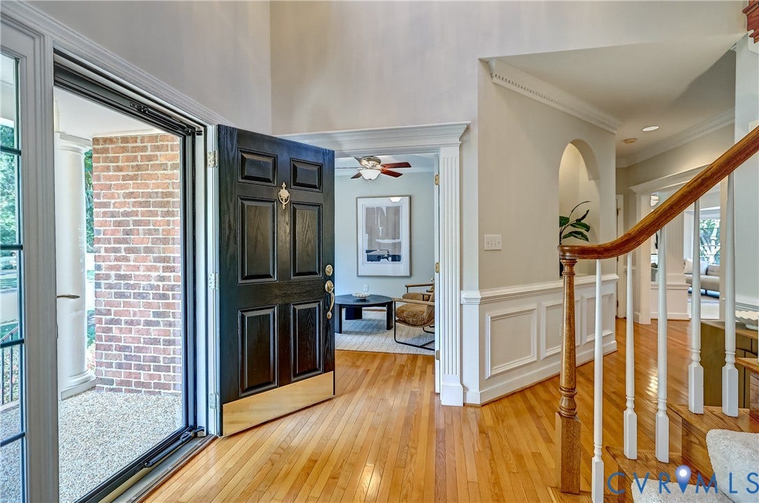5204 Harvest Glen Drive, Twin Hickory, Glen Allen, VA 23059 High ceilings with crown molding, natural wood flooring, a grand staircase with wood newel post and handrail, wainscoting, and an arched entry