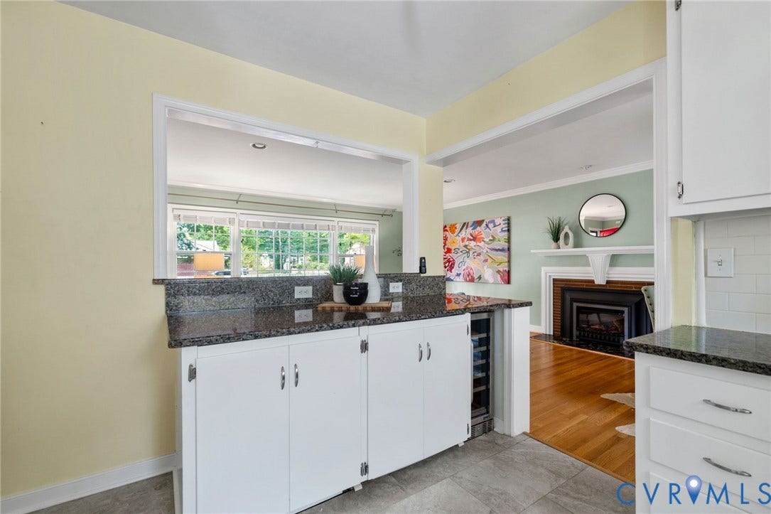 White cabinetry with dark stone countertops