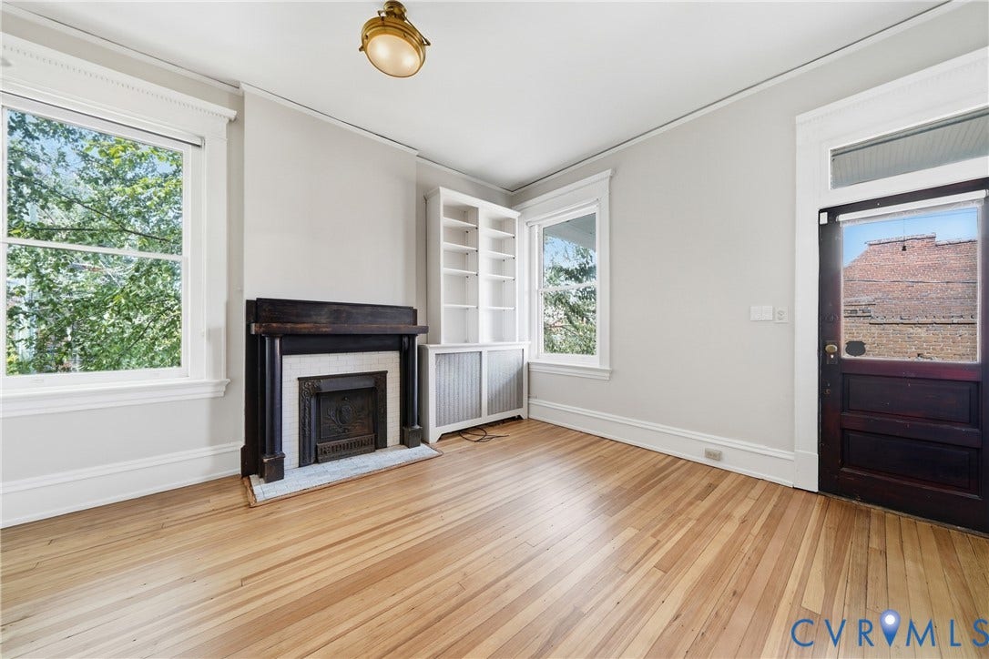 1848 W Grace Street, Historic W. Grace Street, Richmond, VA 23220 Wood-finish flooring, a decorative fireplace with a dark wood mantel, built-in shelving, and large windows