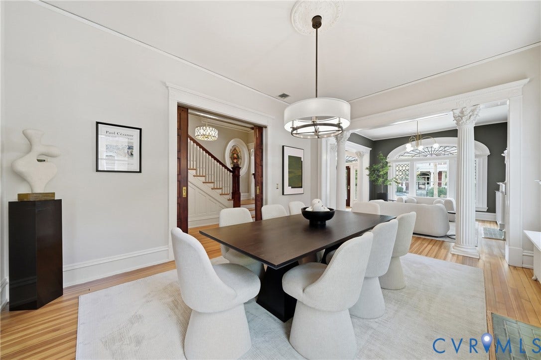1848 W Grace Street, Historic W. Grace Street, Richmond, VA 23220 Hardwood flooring, decorative ceiling medallion, ornate column details, white trim, and a contemporary drum pendant light fixture