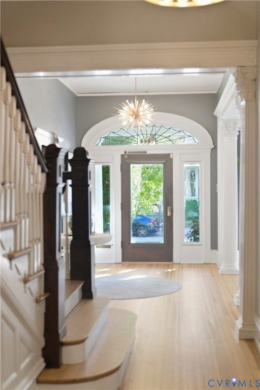 1848 W Grace Street, Historic W. Grace Street, Richmond, VA 23220 Hardwood flooring throughout, grand entry with a decorative chandelier, arched transom window with stained glass, and detailed white columns