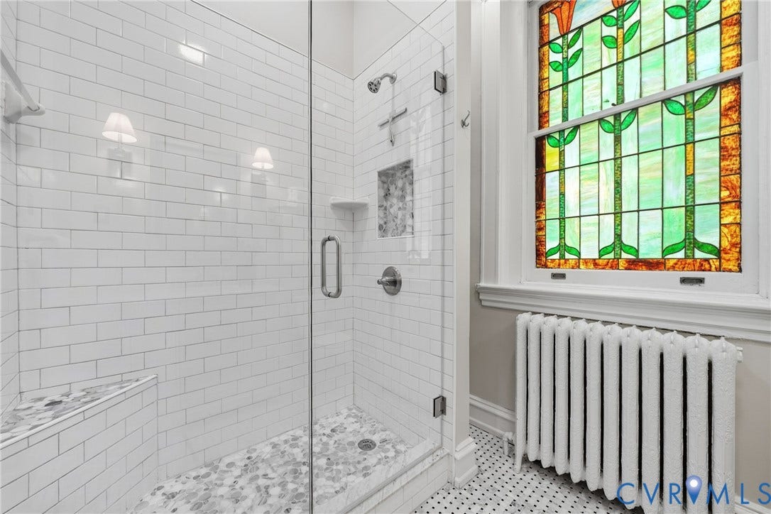 1848 W Grace Street, Historic W. Grace Street, Richmond, VA 23220 Glass-enclosed shower with white subway tile, a built-in shower bench, and a river rock shower floor