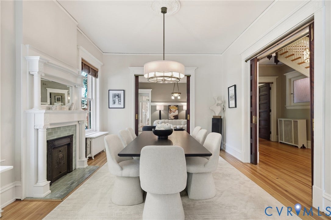 1848 W Grace Street, Historic W. Grace Street, Richmond, VA 23220 Formal dining space featuring a decorative fireplace with tile surround, wood-finish flooring, crown molding, and an ornate ceiling medallion with a chandelier