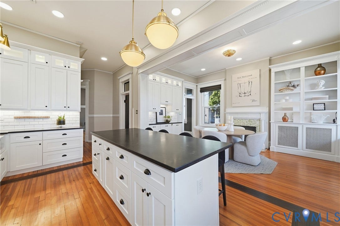 1848 W Grace Street, Historic W. Grace Street, Richmond, VA 23220 Spacious kitchen featuring an expansive center island, white shaker cabinetry, pendant lighting, and wood-finish flooring