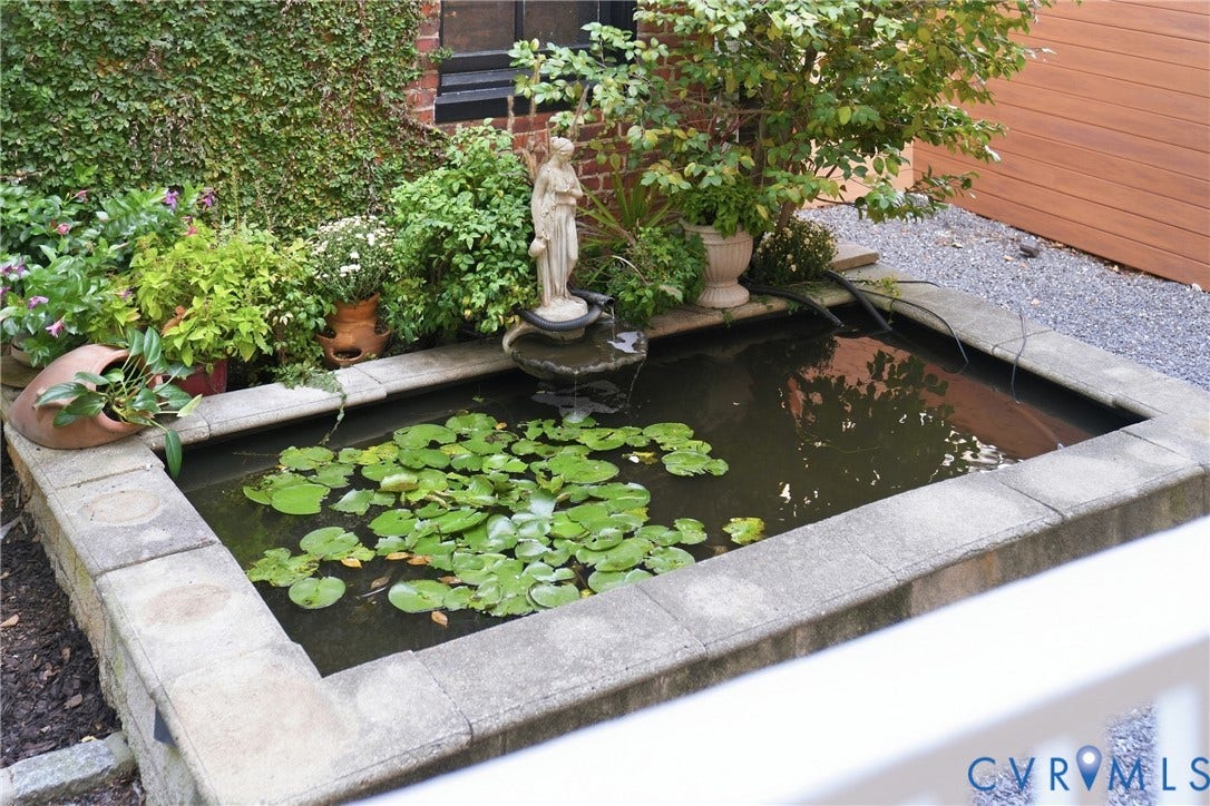 1848 W Grace Street, Historic W. Grace Street, Richmond, VA 23220 Rectangular water feature with a stone surround, integrated fountain, and aquatic plants